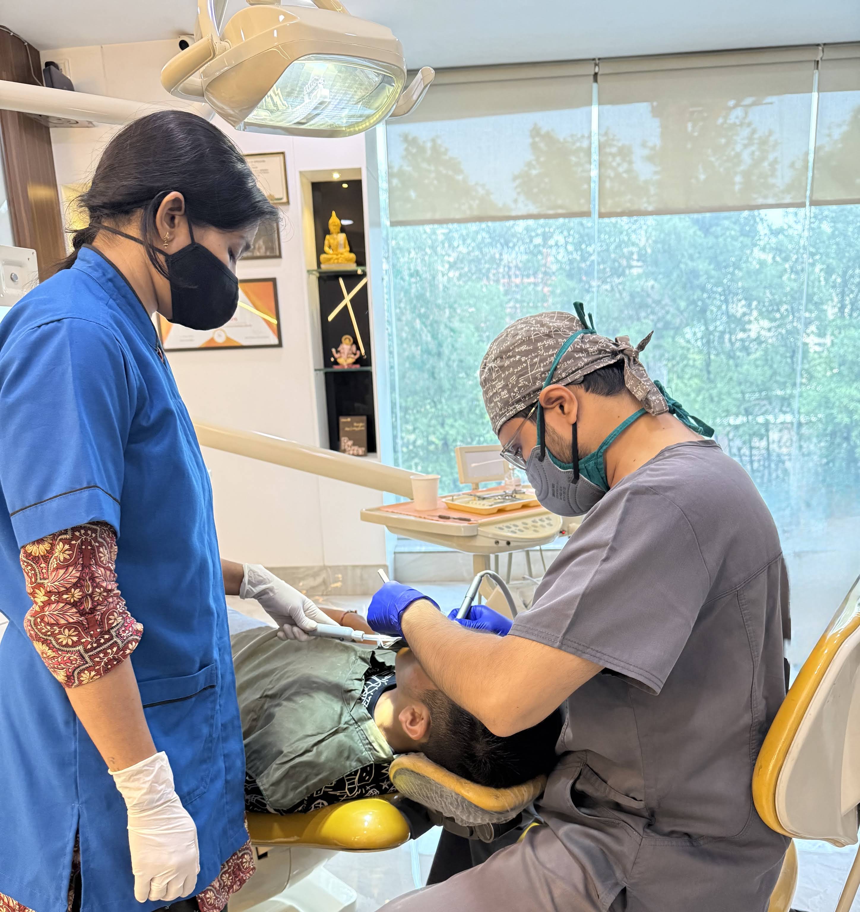 Dr. Nihar treating a patient, assisted chairside
